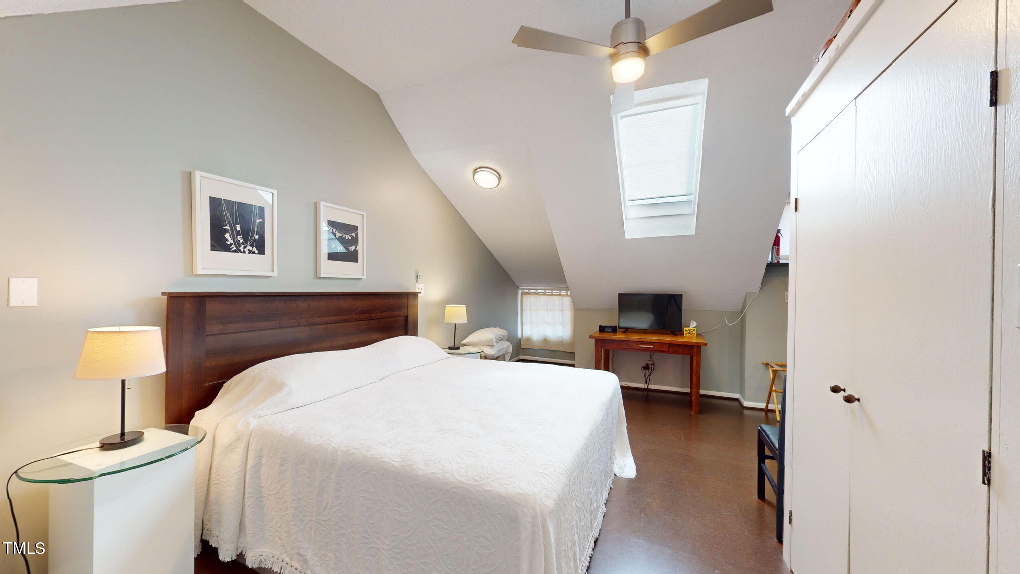 132 Woodburn Road Raleigh, NC 27605 - Photo 36 of 53 a spacious bedroom with a bed and a flat screen tv