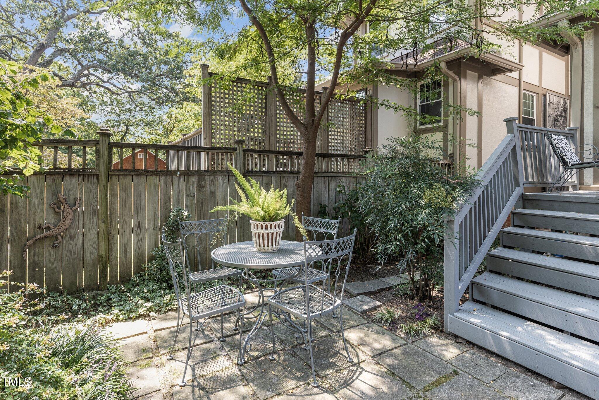 132 Woodburn Road Raleigh, NC 27605 - Photo 41 of 53 a view of a chair and table in backyard of the house