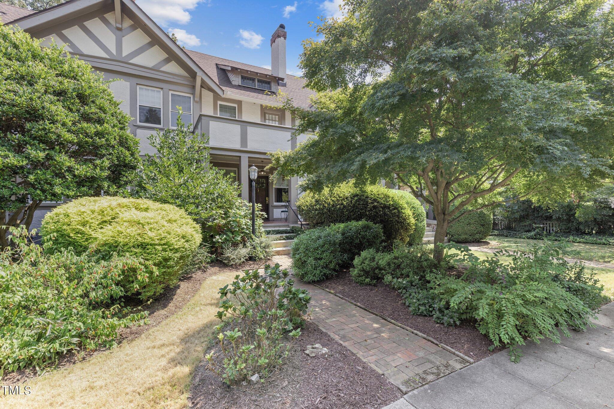 132 Woodburn Road Raleigh, NC 27605 - Photo 5 of 53 a front view of a house with a yard and fountain
