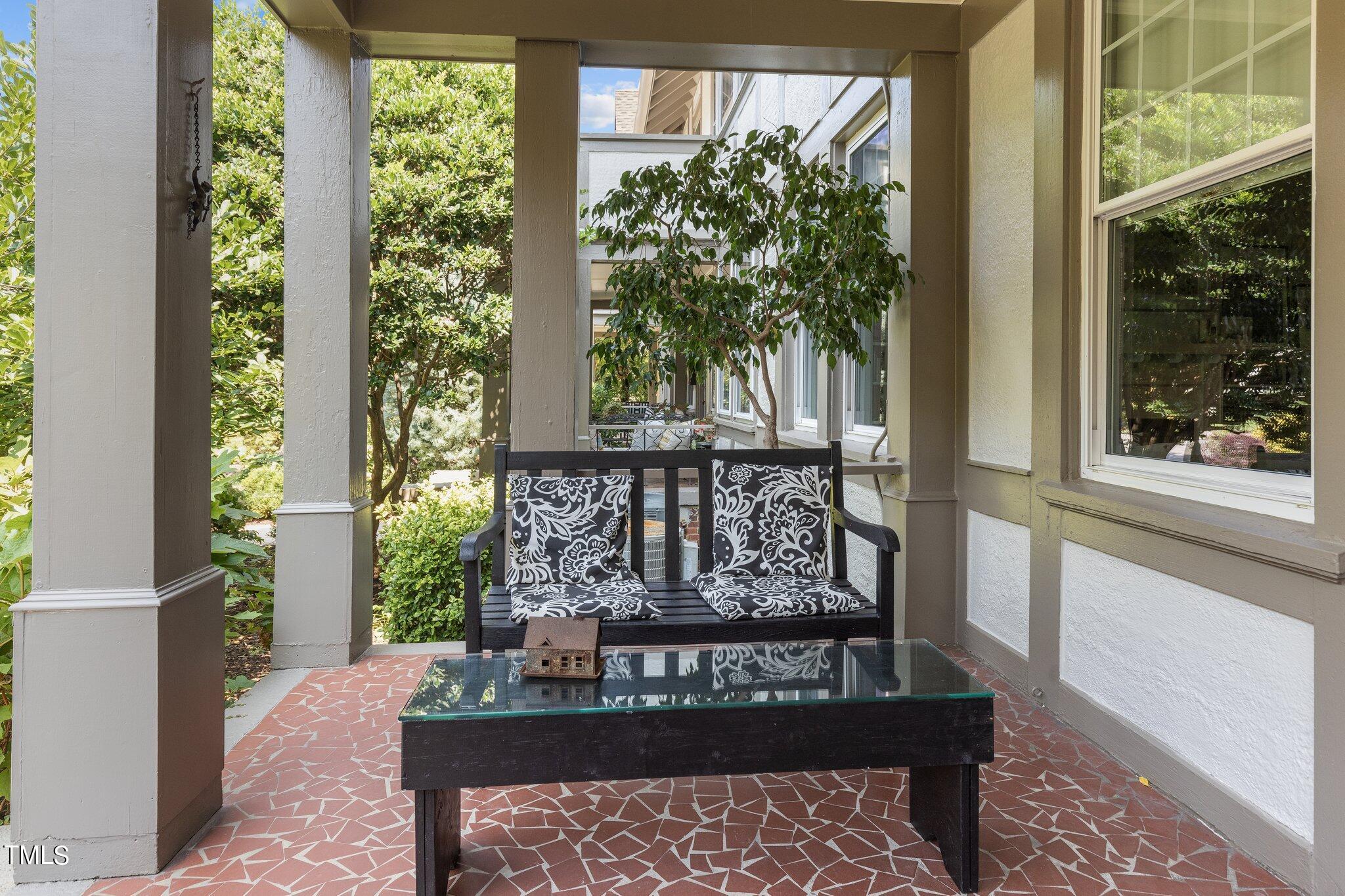 132 Woodburn Road Raleigh, NC 27605 - Photo 9 of 53 a wooden bench sitting in front of a building