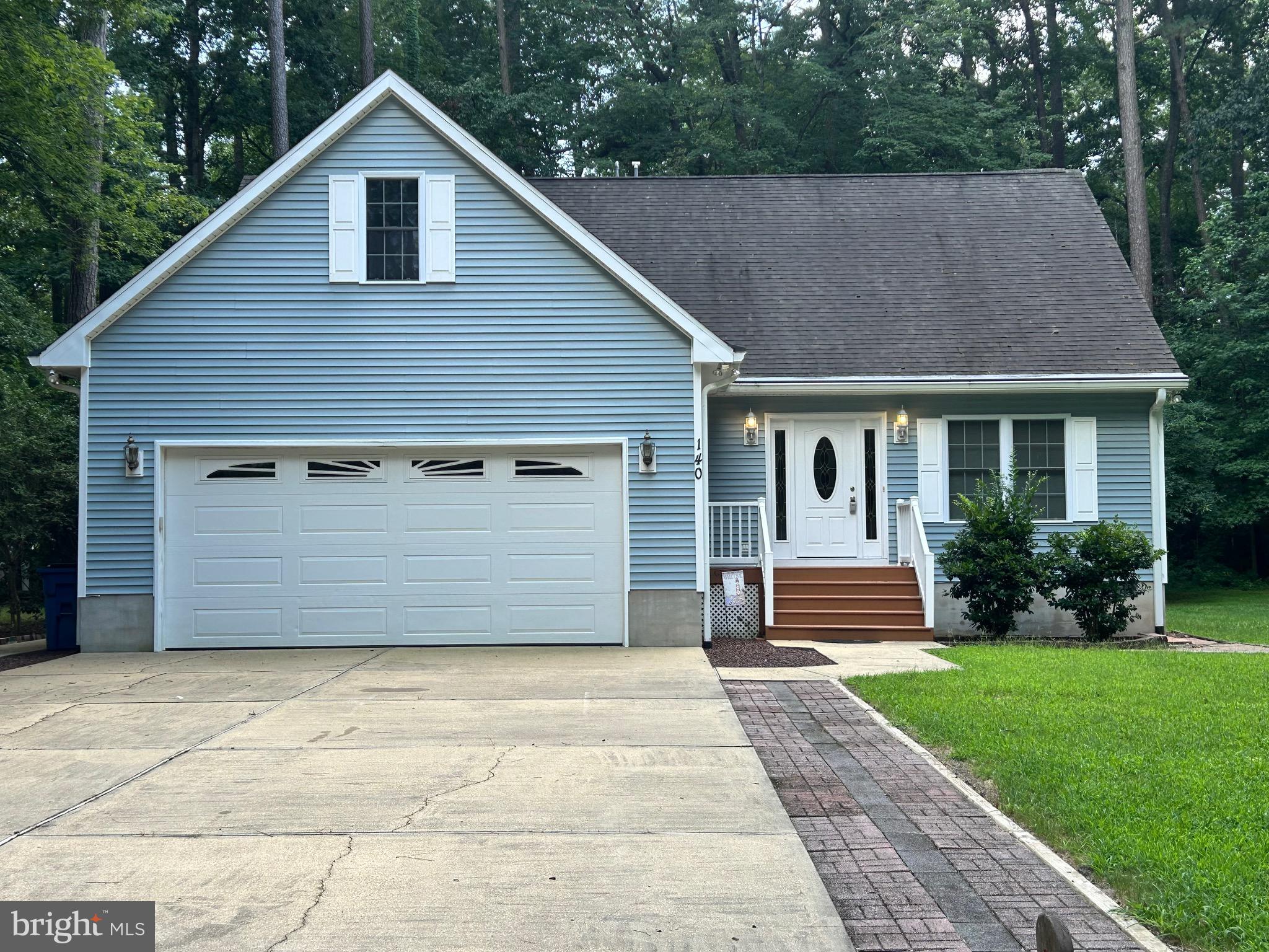 140 Pinehurst Road Ocean Pines, MD 21811 - Photo 1 of 32 a front view of a house with a yard and garage