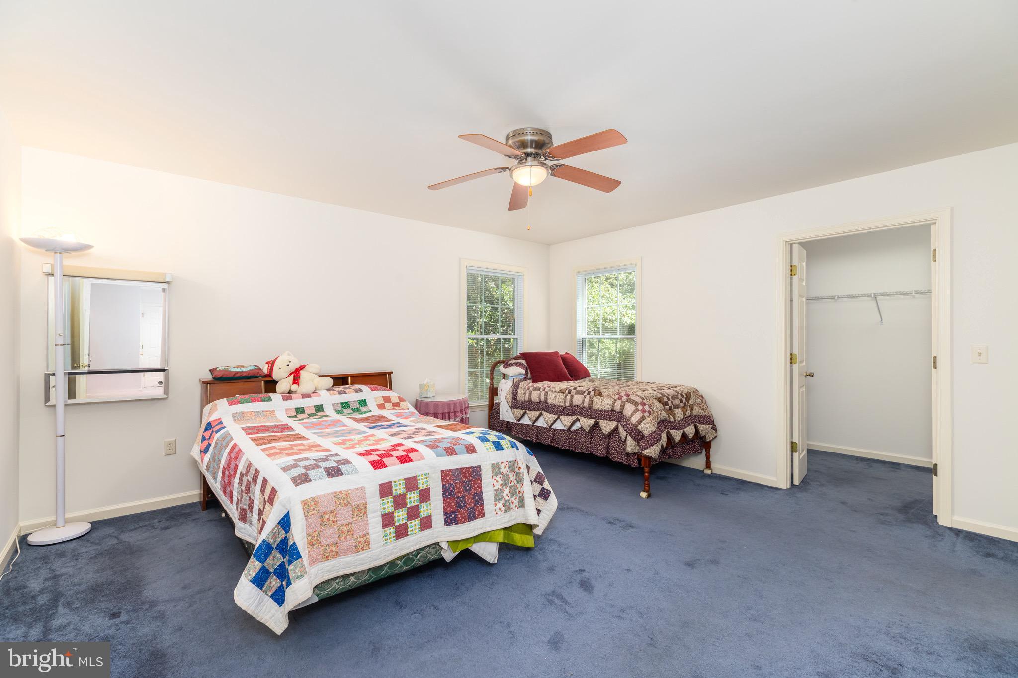 140 Pinehurst Road Ocean Pines, MD 21811 - Photo 13 of 32 a bedroom with a bed and a chandelier