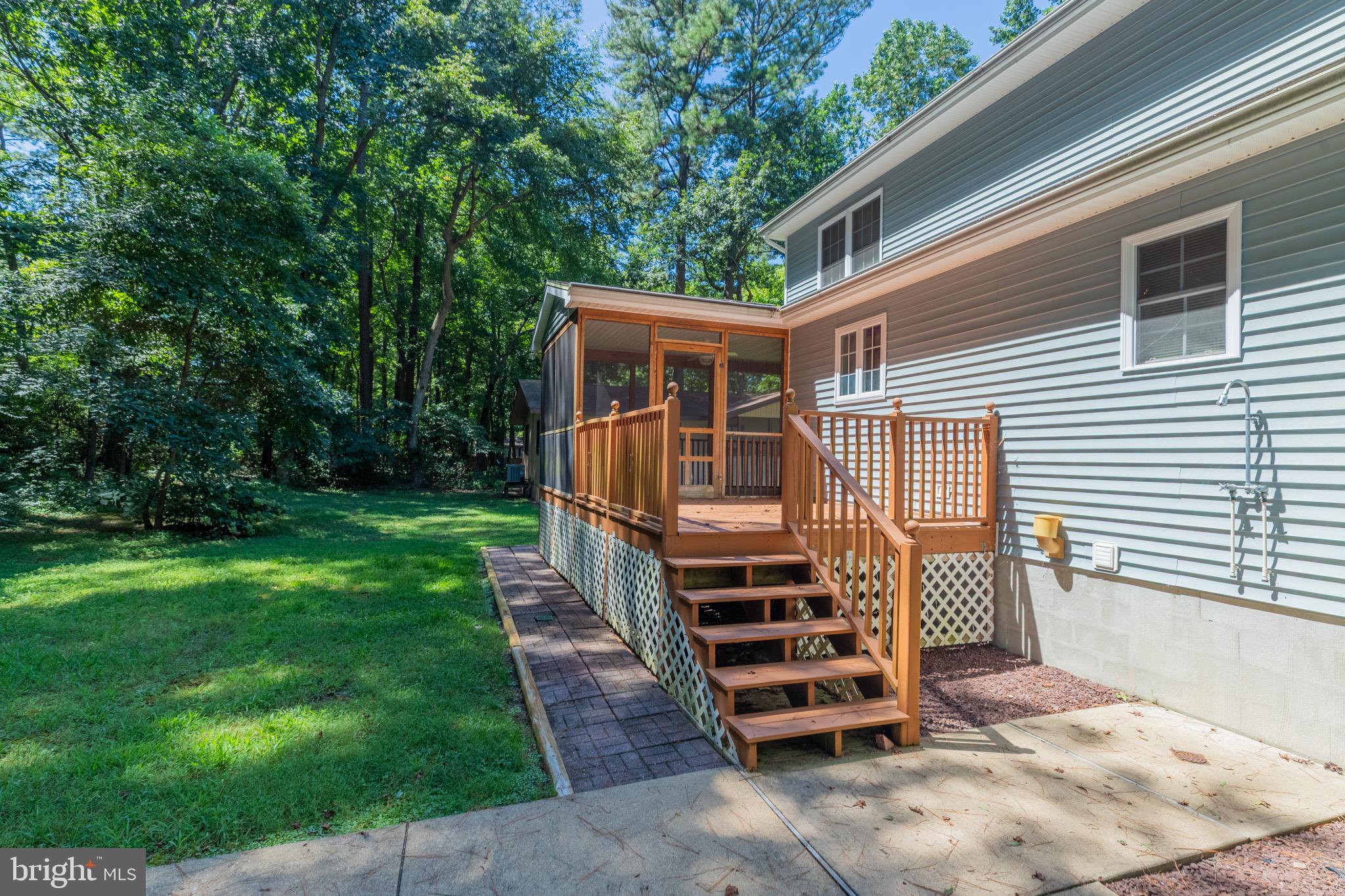 140 Pinehurst Road Ocean Pines, MD 21811 - Photo 21 of 32 a front view of house with yard and trees in the background