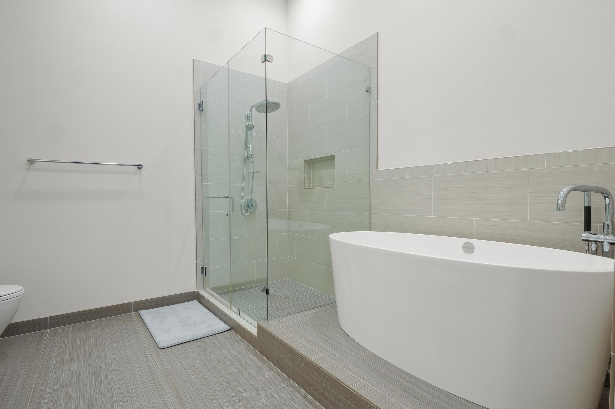 555 East 5th Street, Unit 3022 Austin, TX 78701 - Photo 29 of 40 Full bathroom featuring a freestanding tub and a shower stall