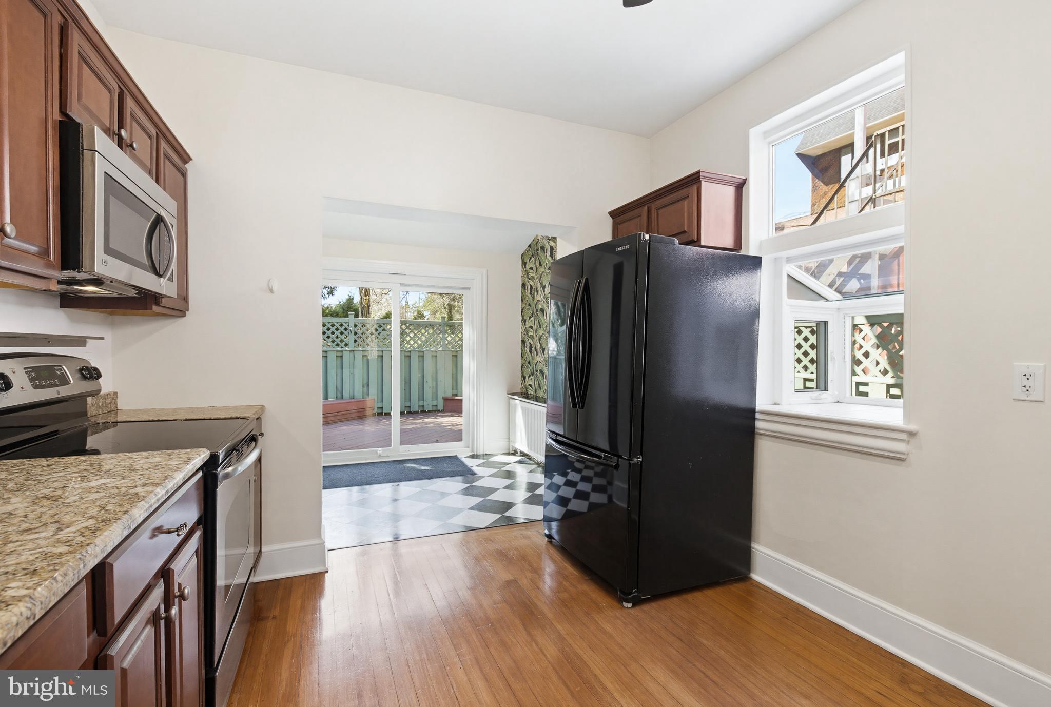 114 North Charlotte Street Lancaster, PA 17603 - Photo 11 of 40 a kitchen with granite countertop a refrigerator and a stove top oven