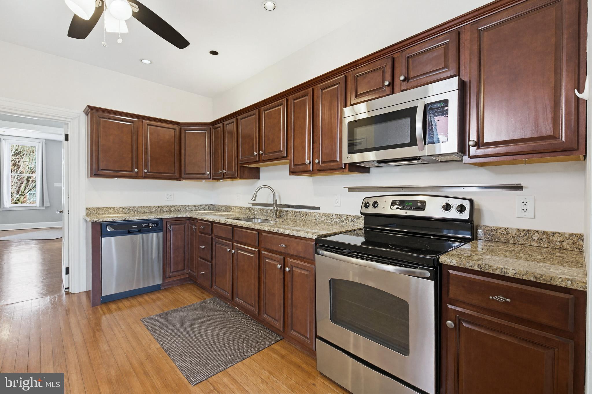 114 North Charlotte Street Lancaster, PA 17603 - Photo 12 of 40 a kitchen with stainless steel appliances granite countertop a stove microwave and sink