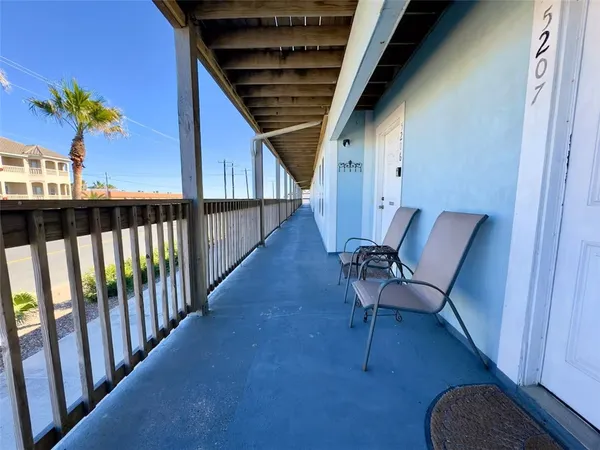 a view of balcony with furniture and wooden floor