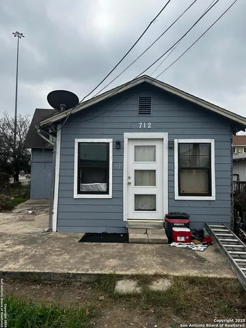 a front view of a house with yard and parking space
