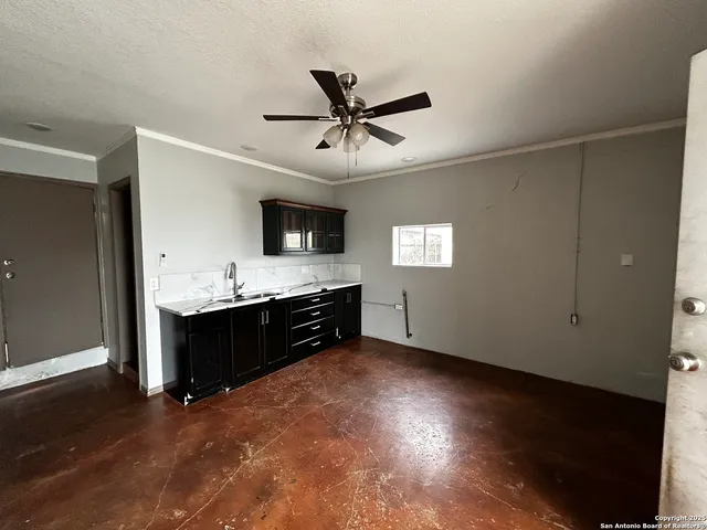 a kitchen with a refrigerator and a stove top oven