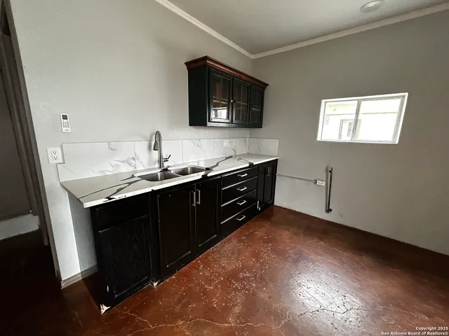 a kitchen with stainless steel appliances a sink and a microwave