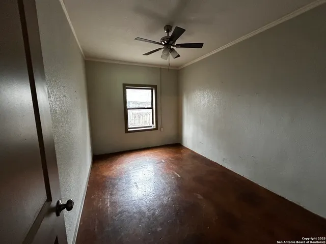 an empty room with windows and closet