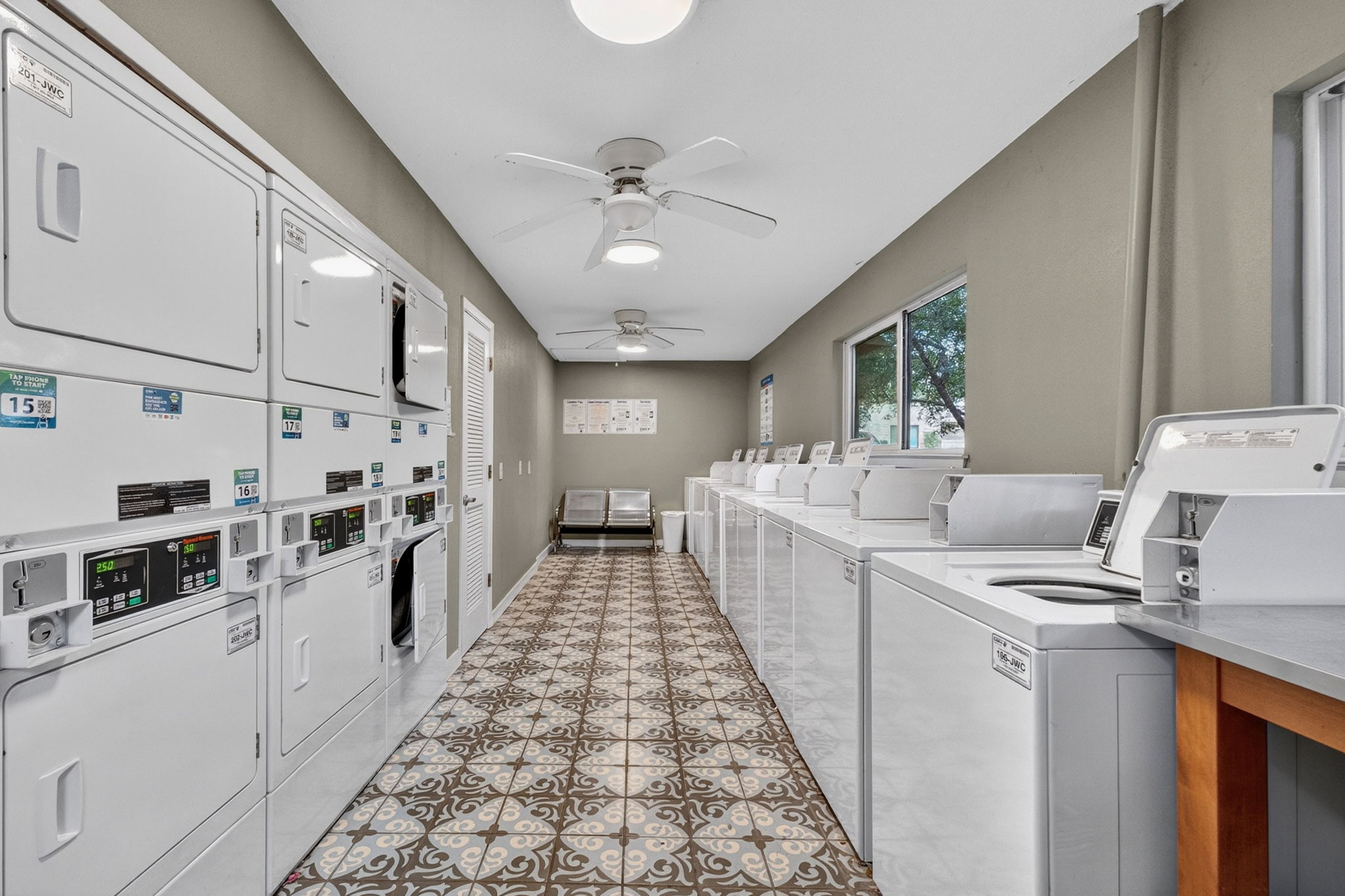 8210 Bent Tree Road, Unit 256 Austin, TX 78759 - Photo 25 of 29 a kitchen with stainless steel appliances a stove top oven cabinets a sink and a window