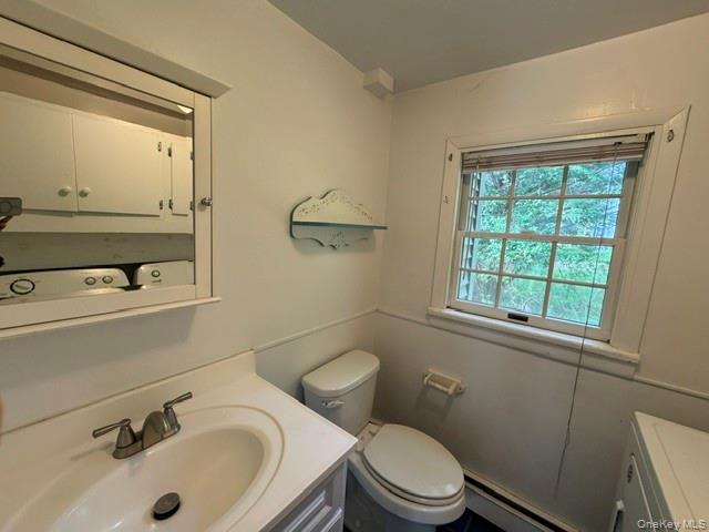 74 South Airmont Road Suffern, NY 10901 - Photo 20 of 42 Bathroom featuring a vanity with an integrated sink, a medicine cabinet, and a window with natural light