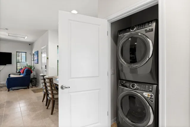 a living room with furniture and a kitchen view