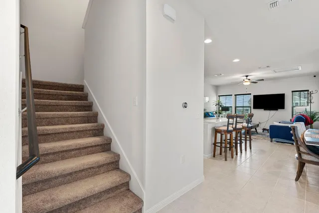 a bedroom with a bed and a flat tv screen on dresser
