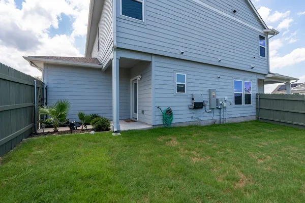 a view of a house with a backyard