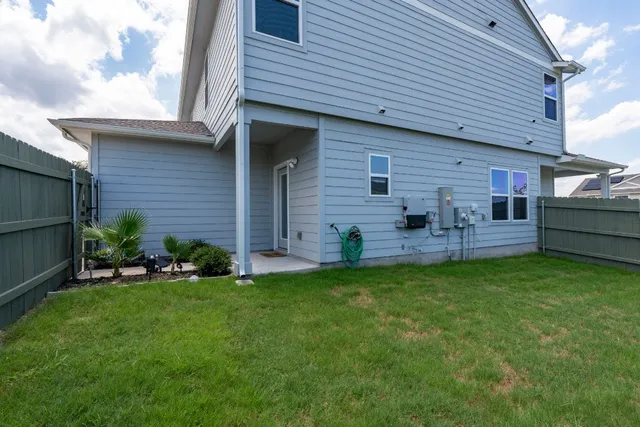a view of a house with a backyard