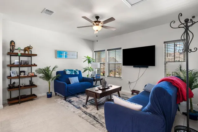 a kitchen with stainless steel appliances kitchen island granite countertop a refrigerator and a stove top oven with white cabinets