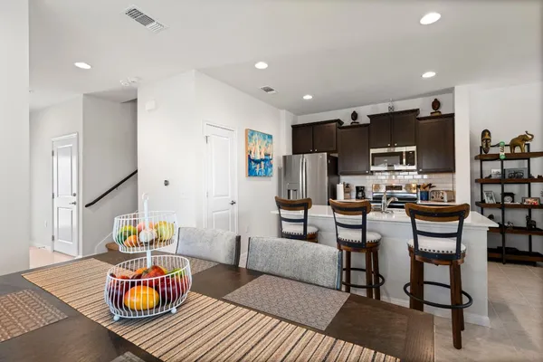 a room with a sink a counter space and living room