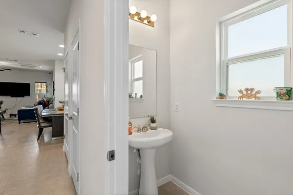 a view of a dining room with furniture and a flat screen tv
