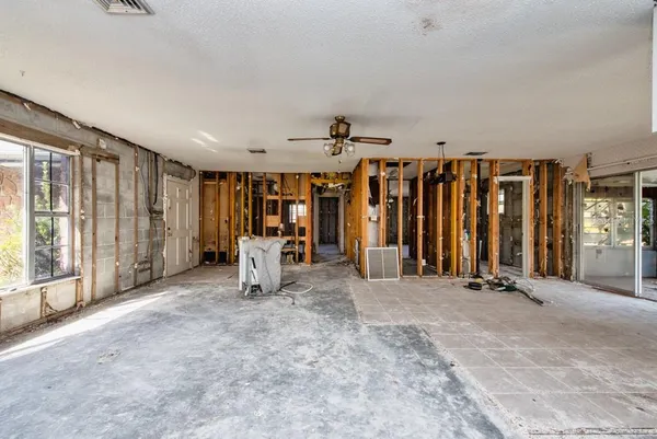 an empty room with stairs and a window