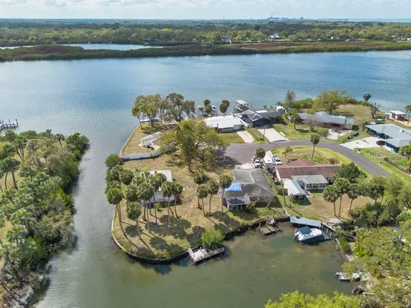 an aerial view of a house with a lake view