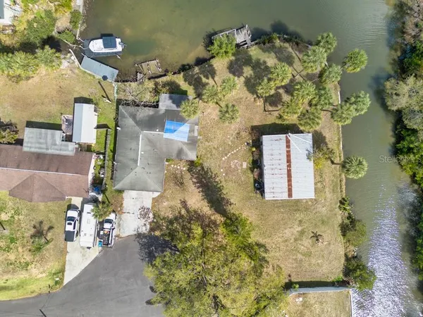 an aerial view of a house with a yard