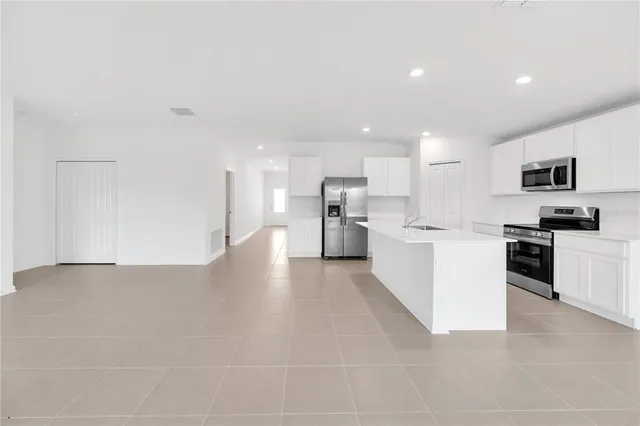 a view of kitchen with refrigerator sink and microwave