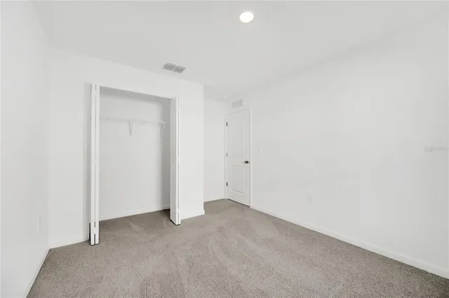 a bathroom with a granite countertop sink a toilet and bathtub