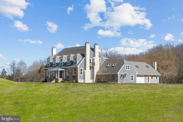 a front view of house with yard and green space