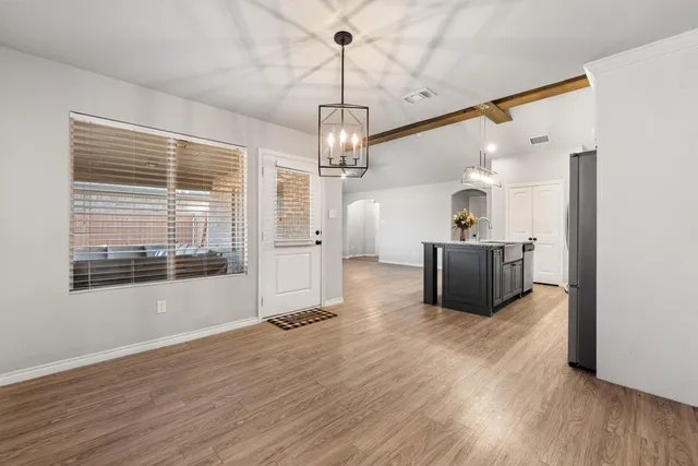 a bathroom with a granite countertop double vanity sink and mirror