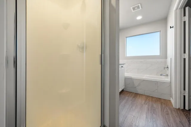 a bed sitting in a bedroom next to a window