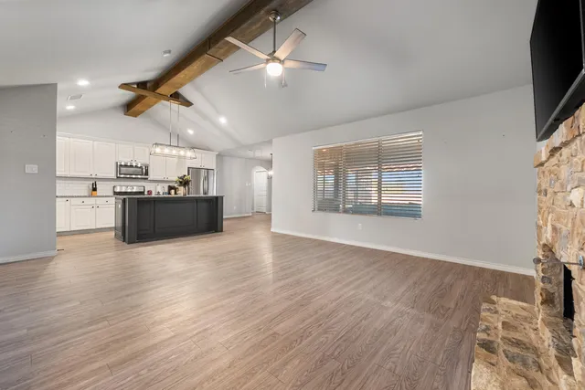 a kitchen with kitchen island a sink stainless steel appliances and cabinets