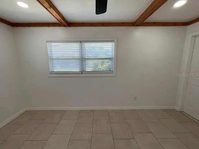 an empty room with a empty space and windows