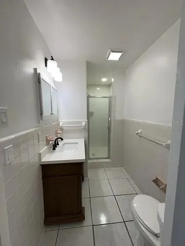 a bathroom with a sink a toilet and mirror