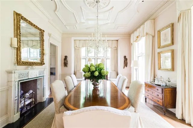 a living room with furniture chandelier and wooden floor