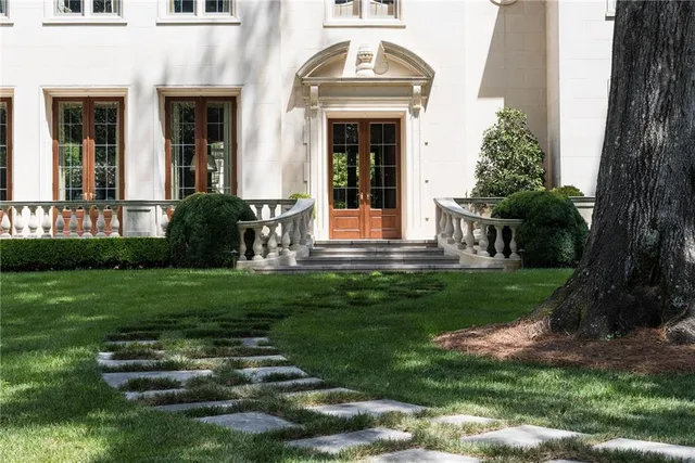 a front view of a house with a garden