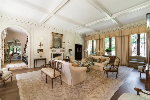 a living room with fireplace furniture and a large window
