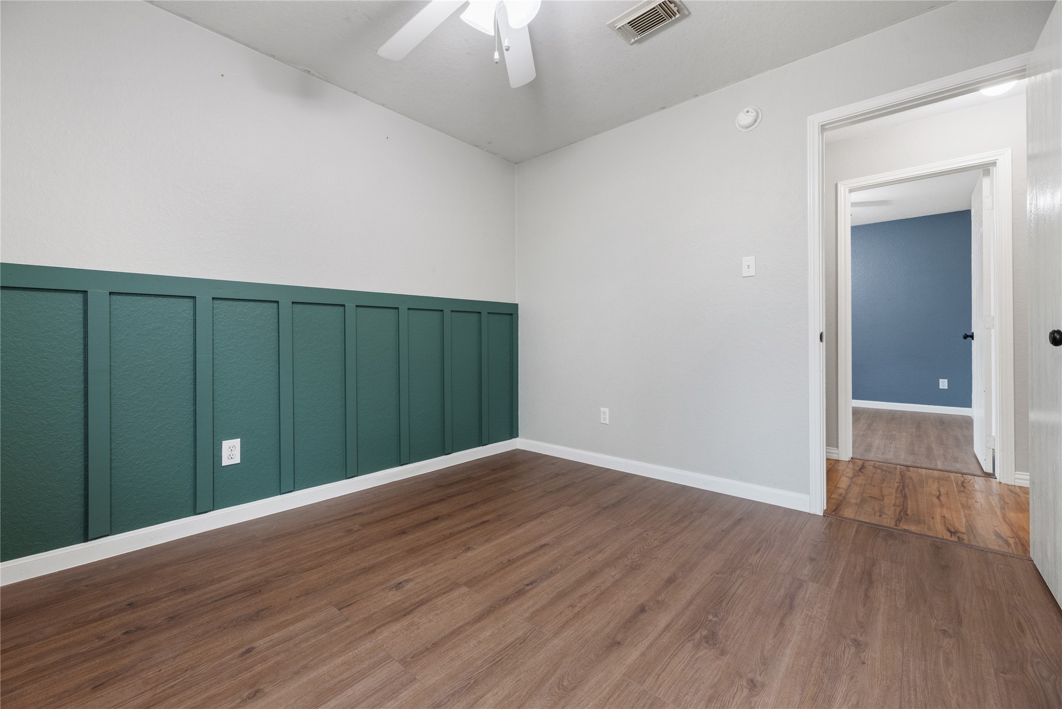 24006 Lazy Kay Lane Hockley, TX 77447 - Photo 14 of 21 This secondary bedroom features laminate flooring and accent walls.