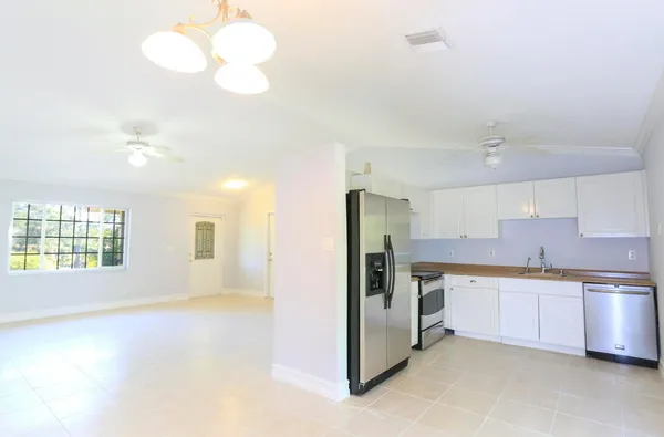 a large kitchen with cabinets and stainless steel appliances
