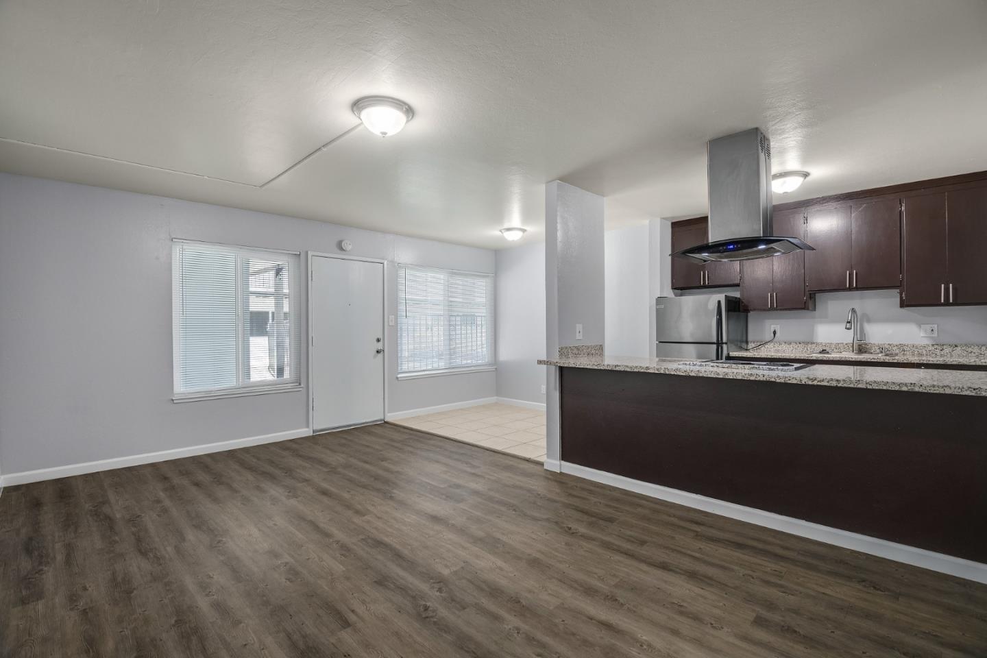 1626 Dwight Way Berkeley, CA 94703 - Photo 6 of 9 a kitchen with granite countertop wooden cabinets a sink and dishwasher