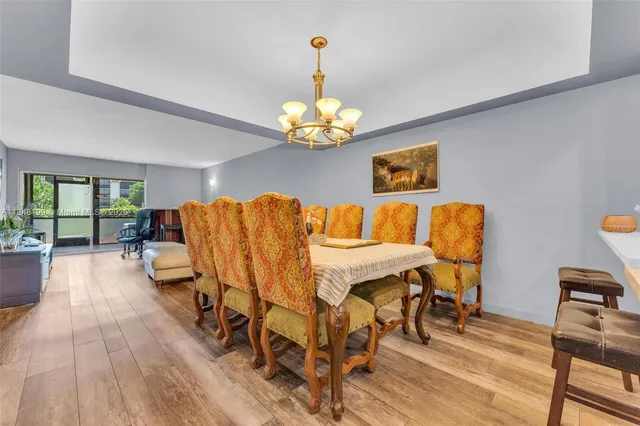 a dining room with furniture and wooden floor