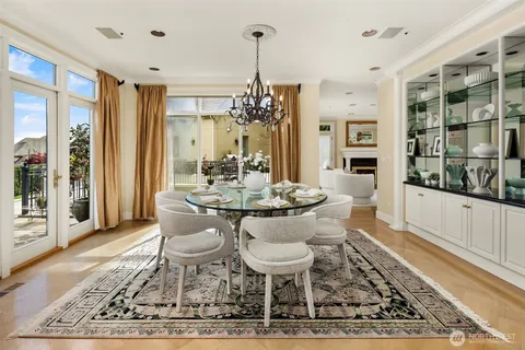 a dining room with wooden floor and a rug
