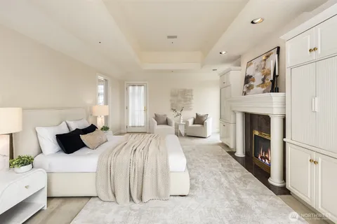 a bedroom with bed and a fireplace