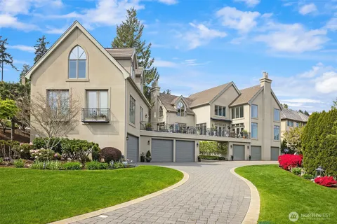 a front view of a house with yard and green space