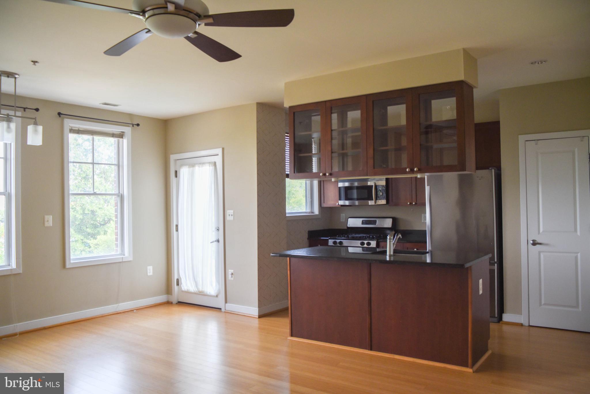 181 East Reed Avenue, Unit 313 Alexandria, VA 22305 - Photo 2 of 7 a kitchen with stainless steel appliances granite countertop a refrigerator and a stove top oven