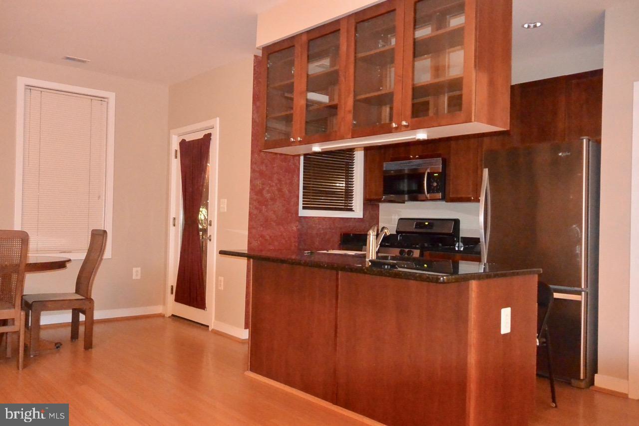 181 East Reed Avenue, Unit 313 Alexandria, VA 22305 - Photo 3 of 7 a view of dining room with furniture and wooden floor