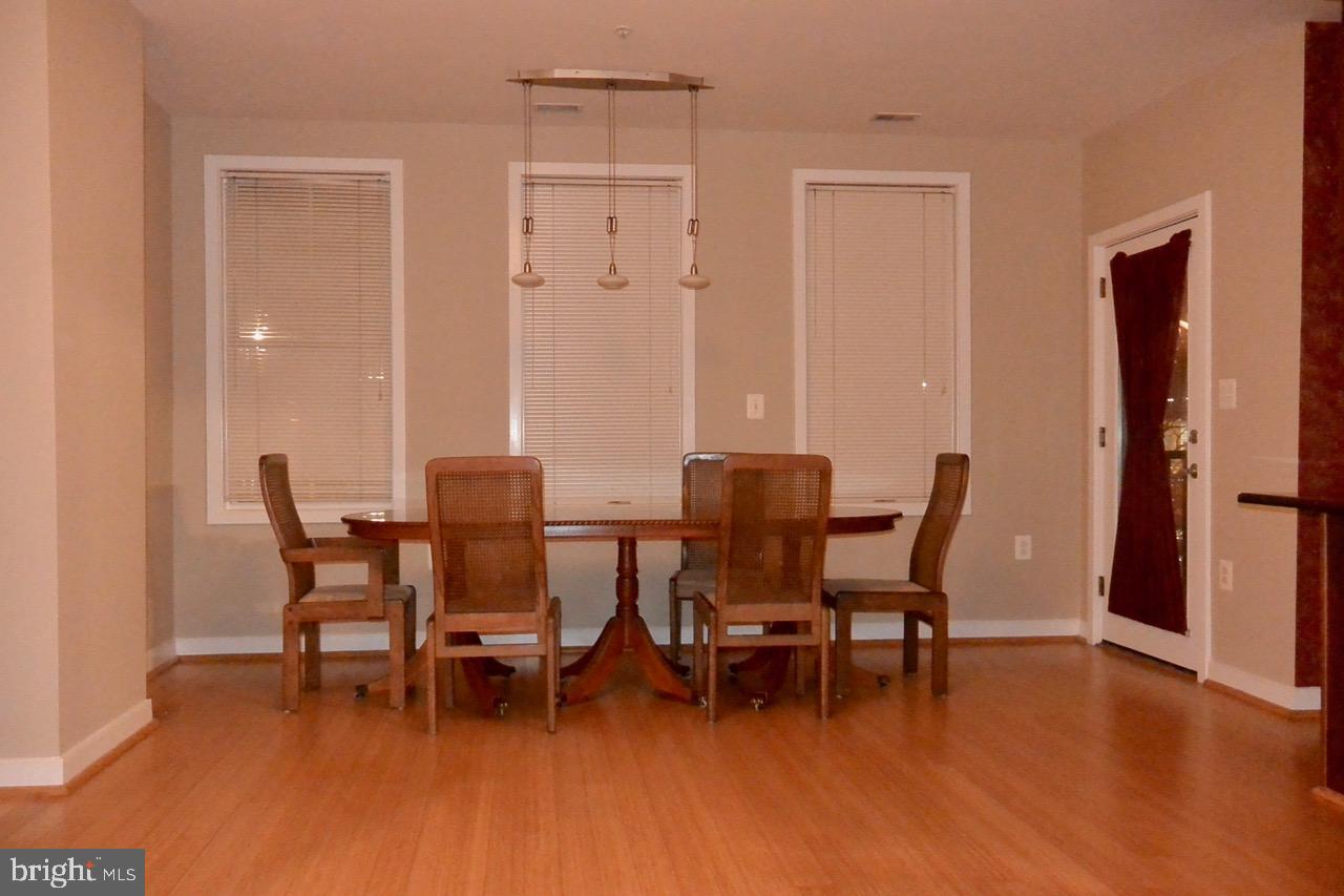 181 East Reed Avenue, Unit 313 Alexandria, VA 22305 - Photo 4 of 7 a view of a dining room with furniture and wooden floor