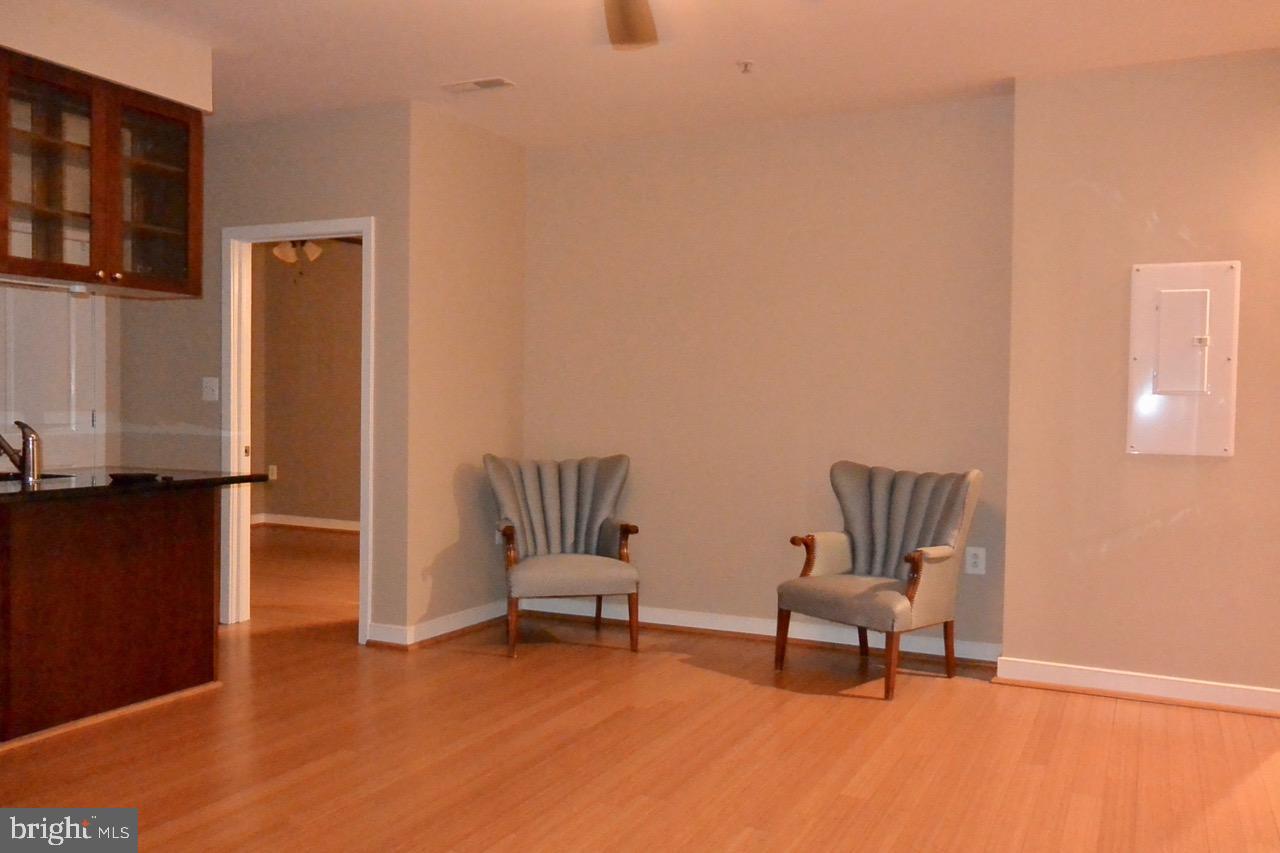 181 East Reed Avenue, Unit 313 Alexandria, VA 22305 - Photo 5 of 7 a living room with furniture and a rug