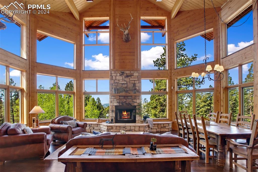 527 Cougar Point Divide, CO 80814 - Photo 8 of 50 a living room with large windows and a fireplace